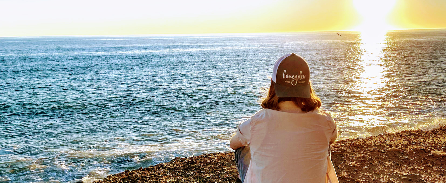 man looking out at ocean sunset